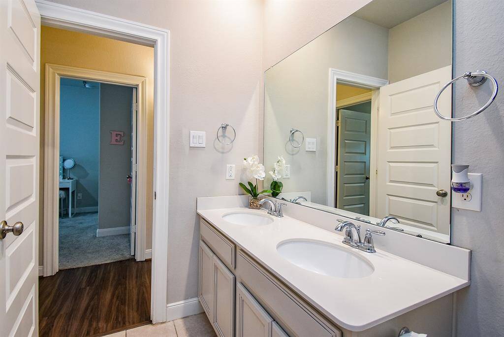 A secondary bathroom is just off bedroom hallways.