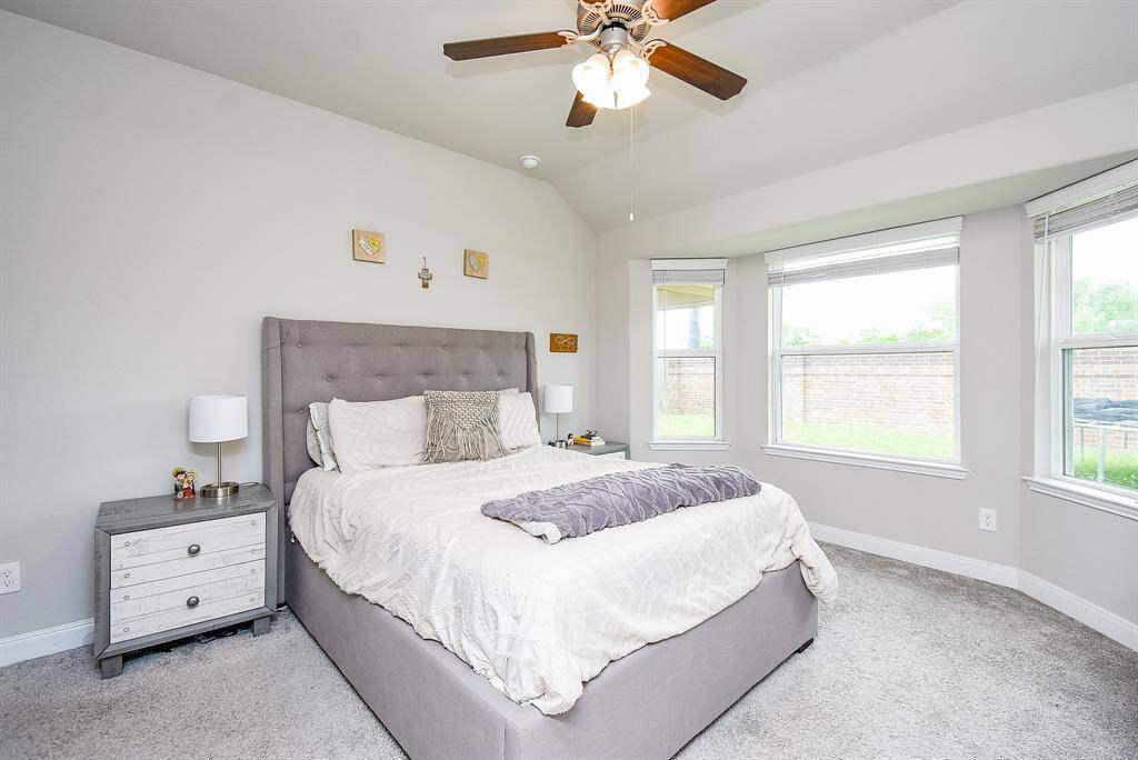 This divine primary suite is a true oasis of rest and repose, with incredible wall and floor space, high ceiling and dreamy bay windows.