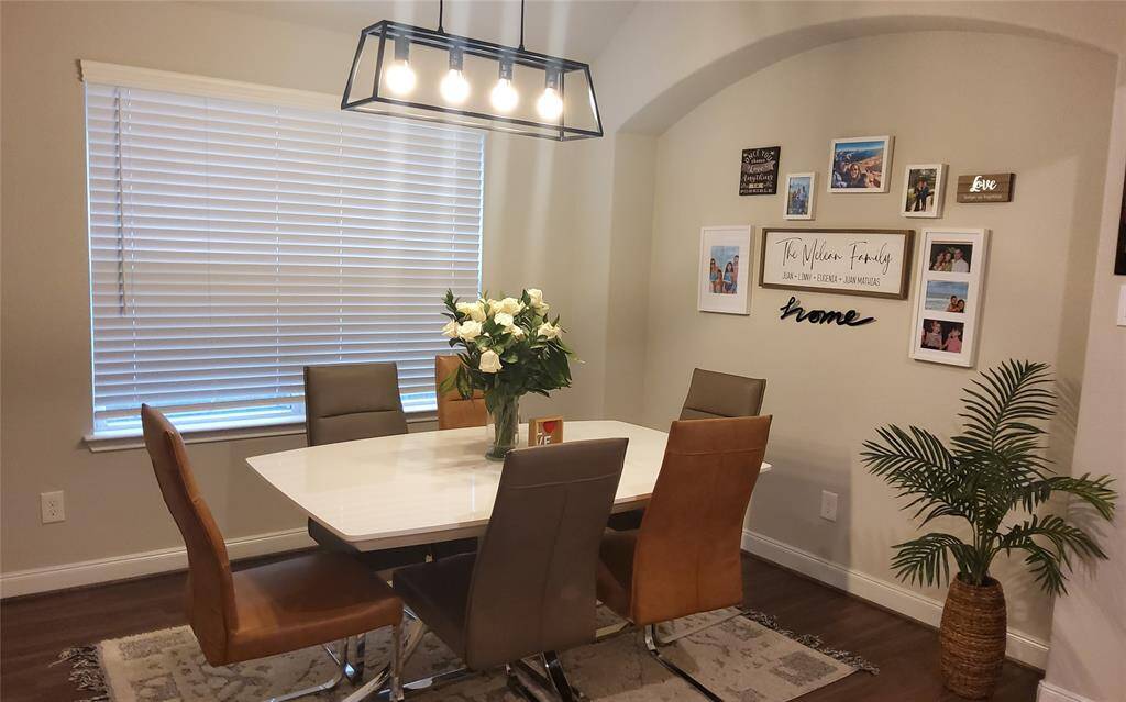 The open floor plan of this amazing home puts you in charge of where you place your treasures; as seen here in the spacious formal dining area, with great natural light, and an expansive wall niche for additional serving/storing pieces or creative expressions, as suggested here.
