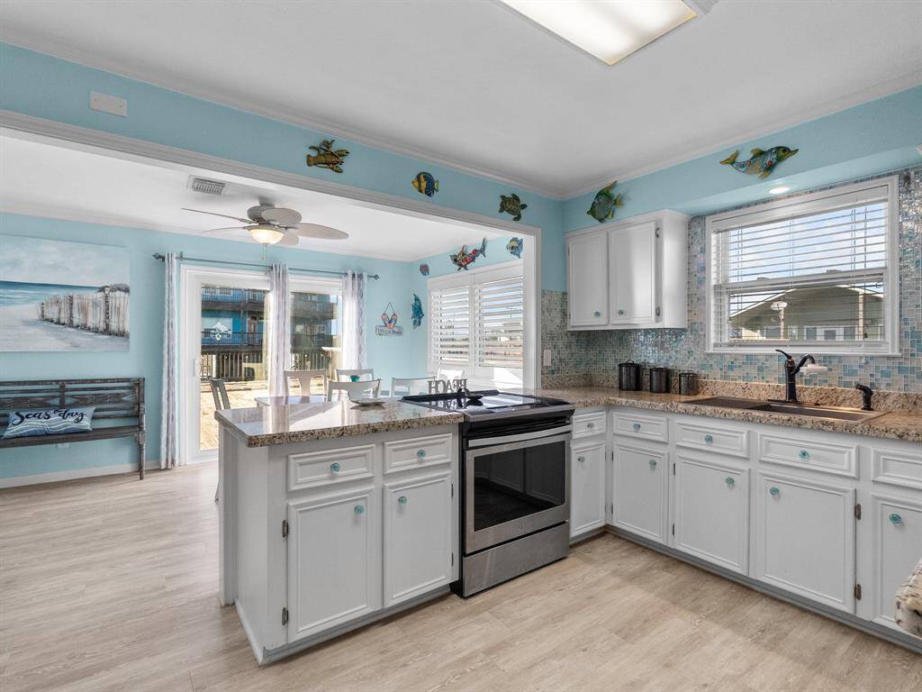 The kitchen looking into the dining area has granite countertops and a breakfast bar or serving bar between the rooms.