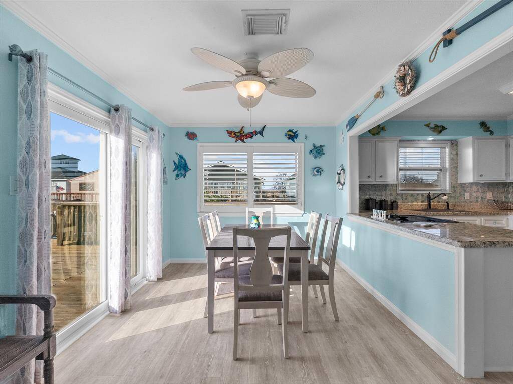 So much natural light in the dining room from the new level 5 hurricane rated sliding doors. The plantation shutters add a touch of elegance to this room.