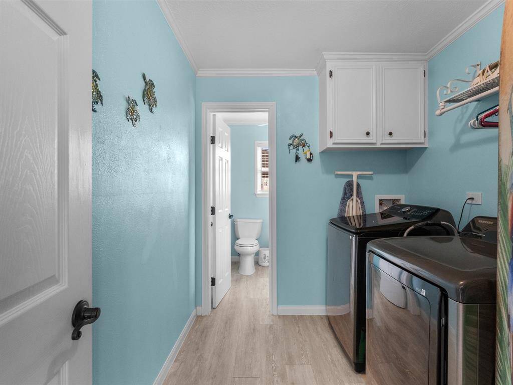 Laundry room with a half bath attached on first floor.