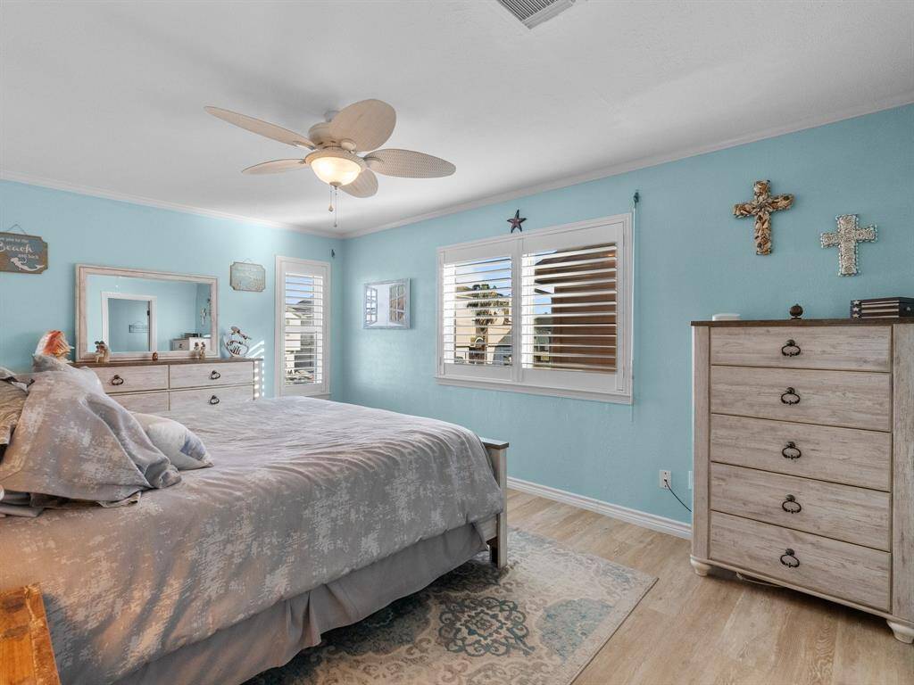Primary bedroom with plantation shutters and new Storm Tight Windows. Notice the roll down shutters that are throughout entire house.