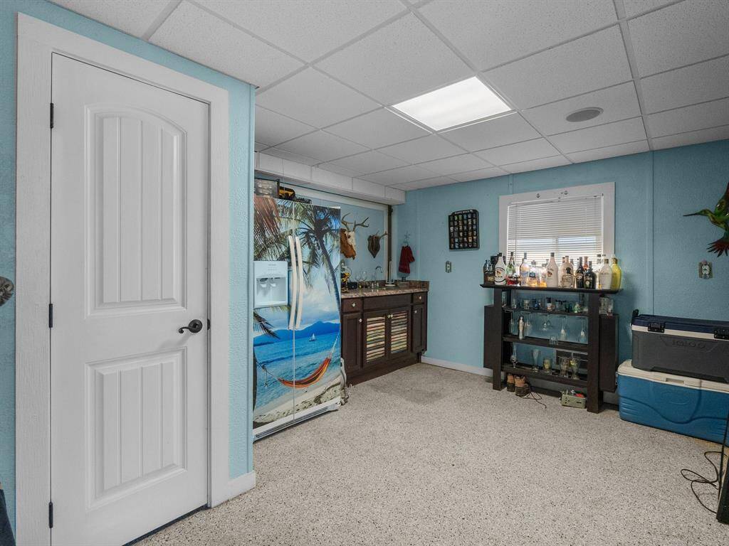 This room is the She "Man Cave" or any other room you may need down under the home.  It has a half bath, wet bar, cabinetry that matches the custom wall, room for refrigerator or storage for coolers.