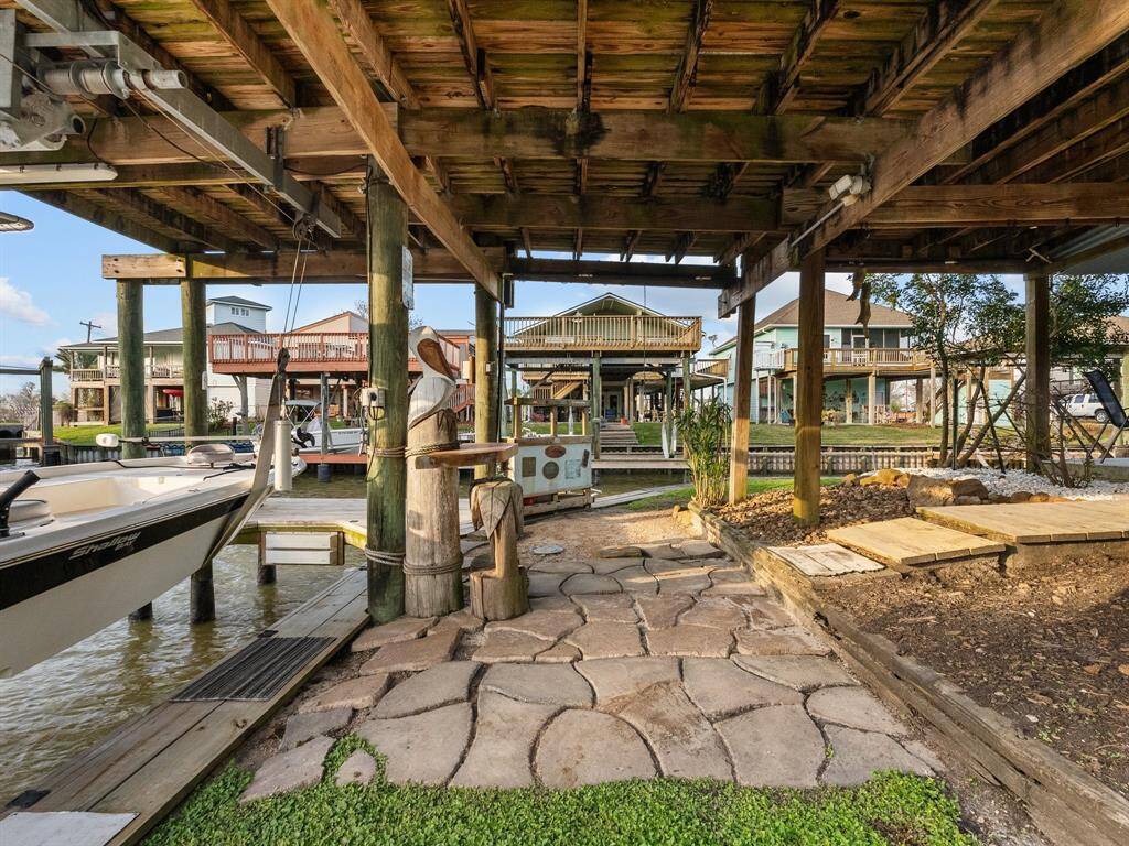 Covered boat dock with boat lift and fish cleaning station.  Jump in your boat and head to one of the many restaurants in the area that accommodate boats! Or fish all day and head over to Topwater Grill and have them cook your catch of the day!