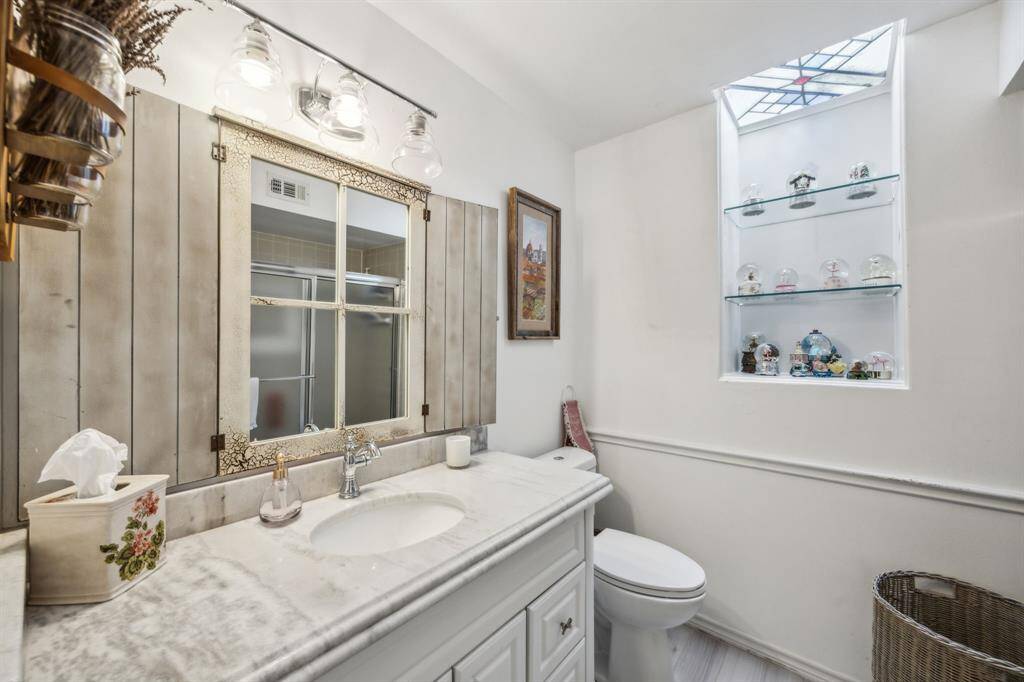 Shared guest bath with custom details including a stained glass sky light.
