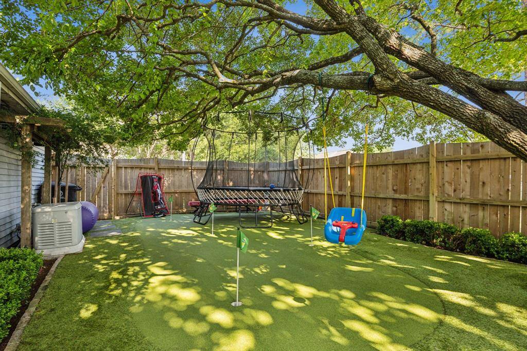 Putting green area shaded by a beautiful Fringe tree.