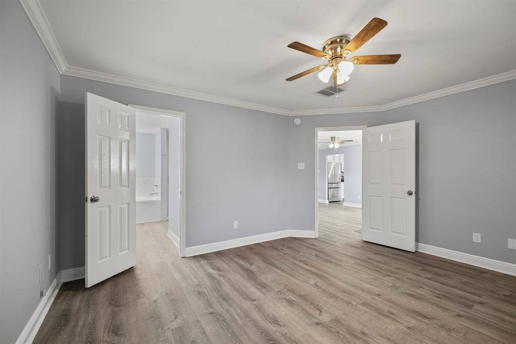 Another angle of the master bedroom shows the door leading out to the alcove off the living room & open to the luxurious ensuite bathroom.