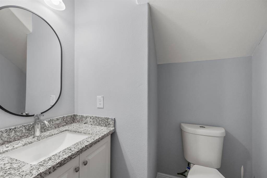 Conveniently located off the main living area, this stylish first-floor half bathroom offers both function and flair. A crisp white vanity adds a clean, modern touch, beautifully topped with a polished quartz countertop that exudes elegance.