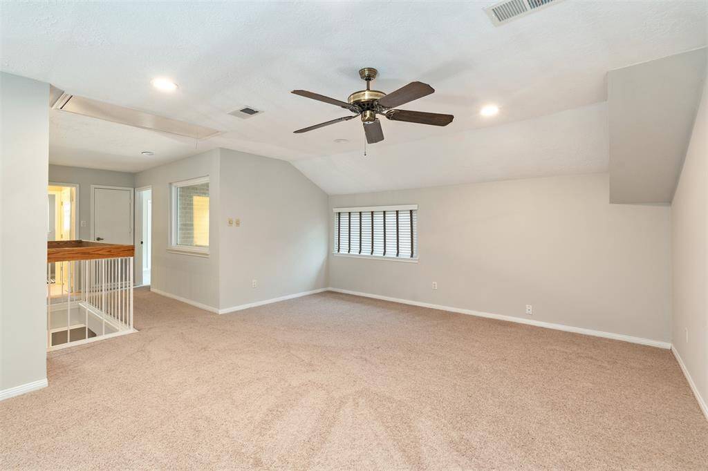 The upstairs has a large game room/den that overlooks the living area below.
