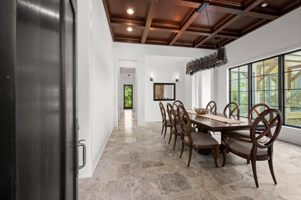 The dining or lounge greets your guests and is highlighted with the coffered walnut ceiling.