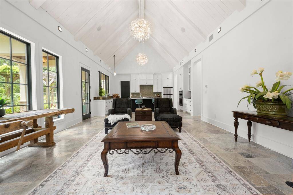 The consistent use of natural textures, refined indoor-outdoor connectivity, and decorative details provide a welcoming yet sophisticated ambiance.