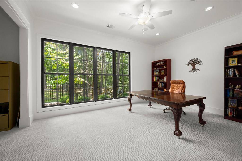 The third downstairs bedroom, also includes a sizeable walk-in closet,  is perfectly outfitted for a dedicated study with nook for networking & office equipment