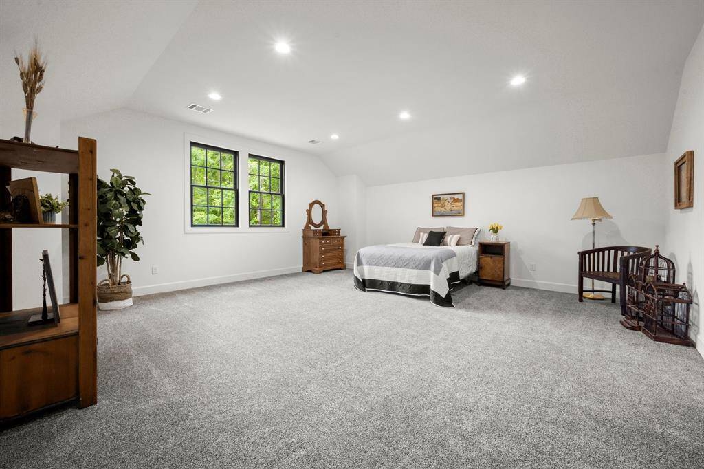 Well-proportioned upstairs guest suite provides the best view of the backyard landscape and pond.