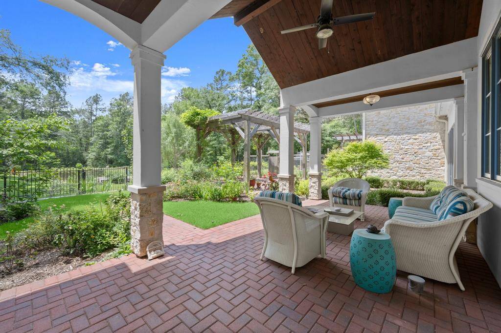 Wooden beadboard vaulted patio cover complete with outdoor ceiling fan.