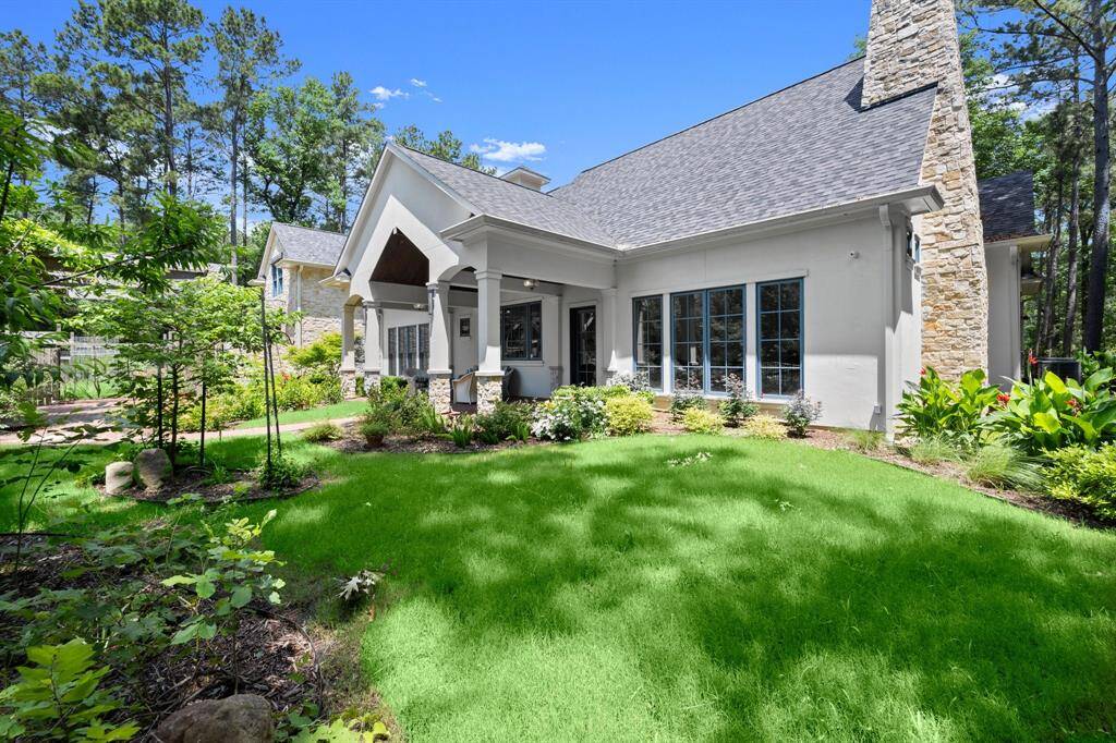 A true stacked stone chimney provides the French charm to the home's back exterior elevation.