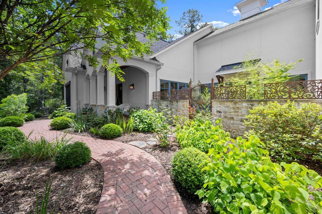 Welcomed with a cobble-paved walkway through a variety of native plants, ornamental trees, and flowering shrubs.