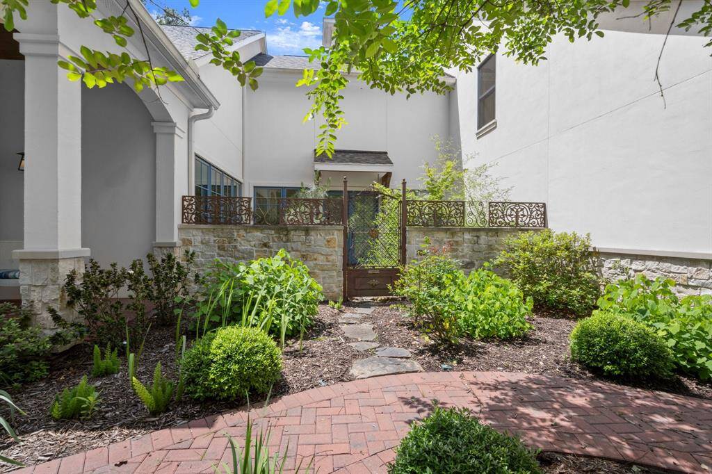 Past the Japanese courtyard landscape with a 1700s French wrought iron gate & accents.