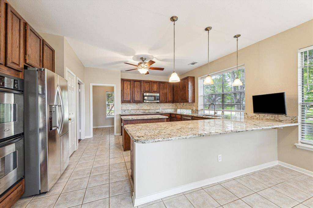 Updated kitchen with granite countertops and stainless appliances. You can easily put barstools here too!