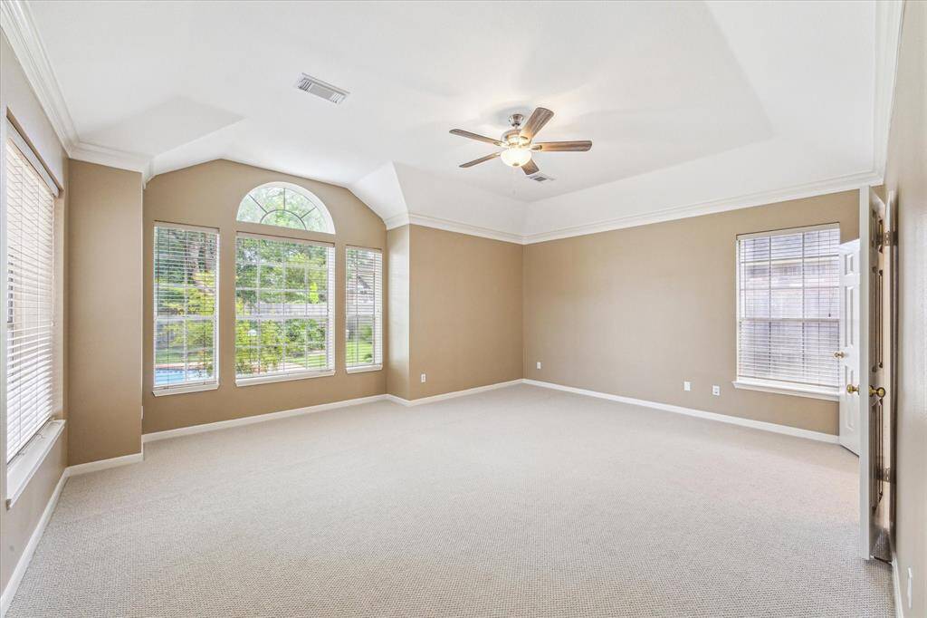 Spacious primary bedroom with new carpet and fresh paint.