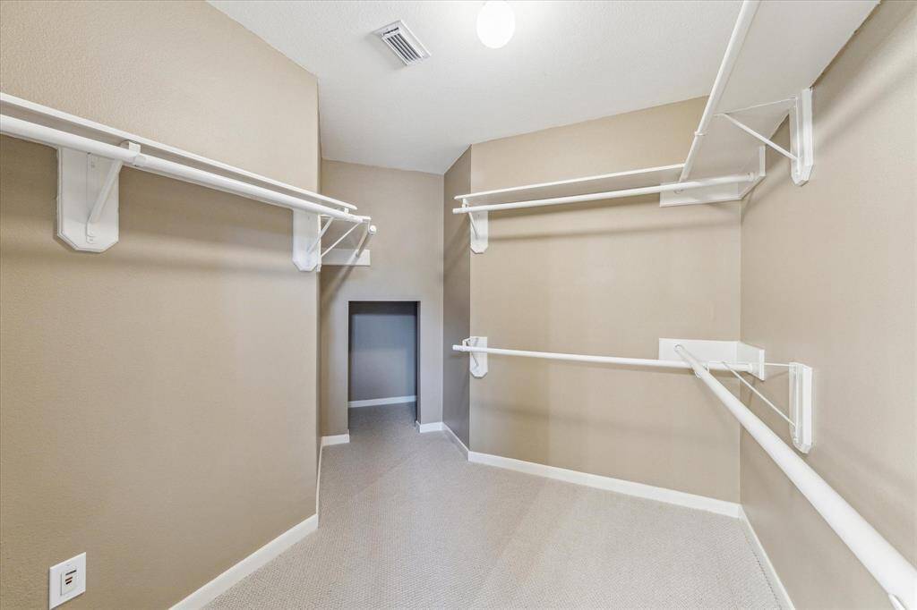 The primary closet has plenty of room.