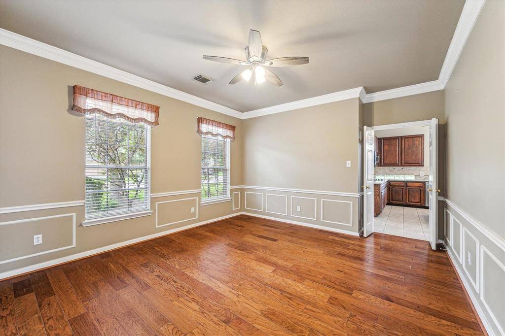 Formal dining room with a view into the kitchen.