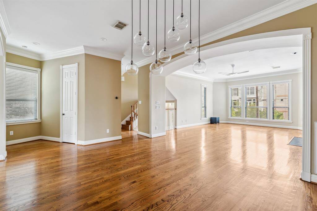 Dining area looking back toward the living room, showing open-concept layout and great natural light.