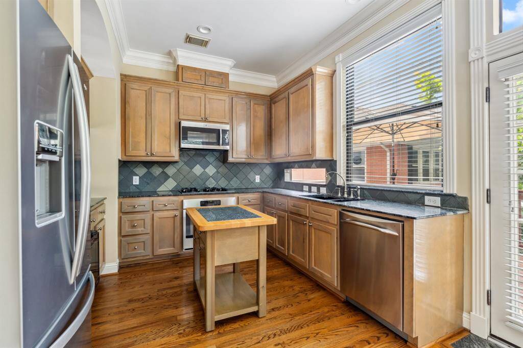 View into the kitchen from the breakfast area, showing open sightlines and efficient layout.
