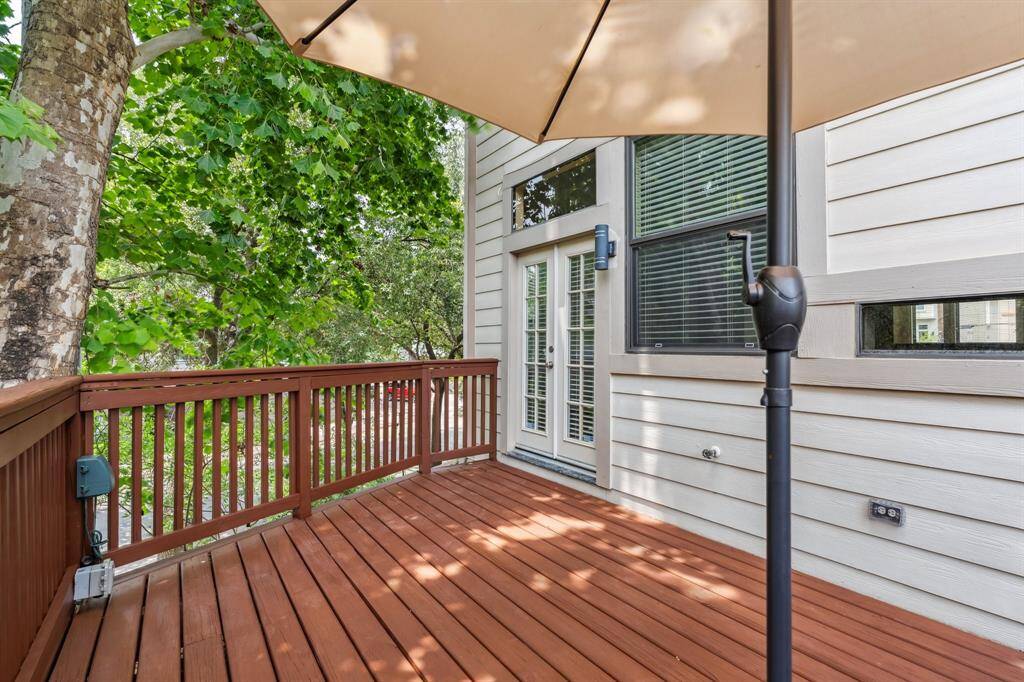 Balcony view showing peaceful tree canopy and extra outdoor space just off the main living area.