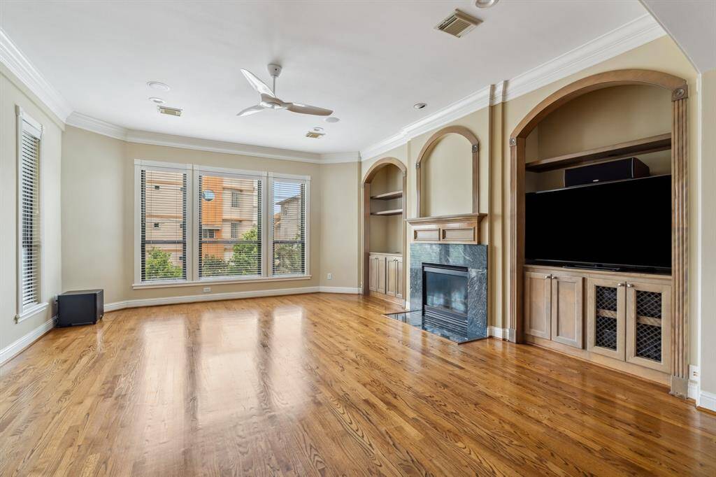 Light-filled second floor living space with hardwood floors, double-paned windows, and open flow for easy entertaining.