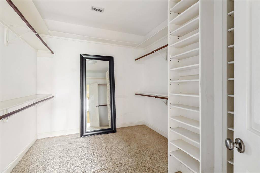 Walk-in closet in the primary suite with built-ins and great storage capacity.