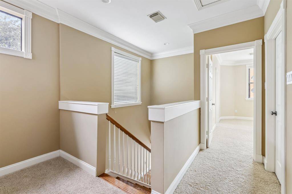 Third floor landing providing a quiet transition space and additional storage.