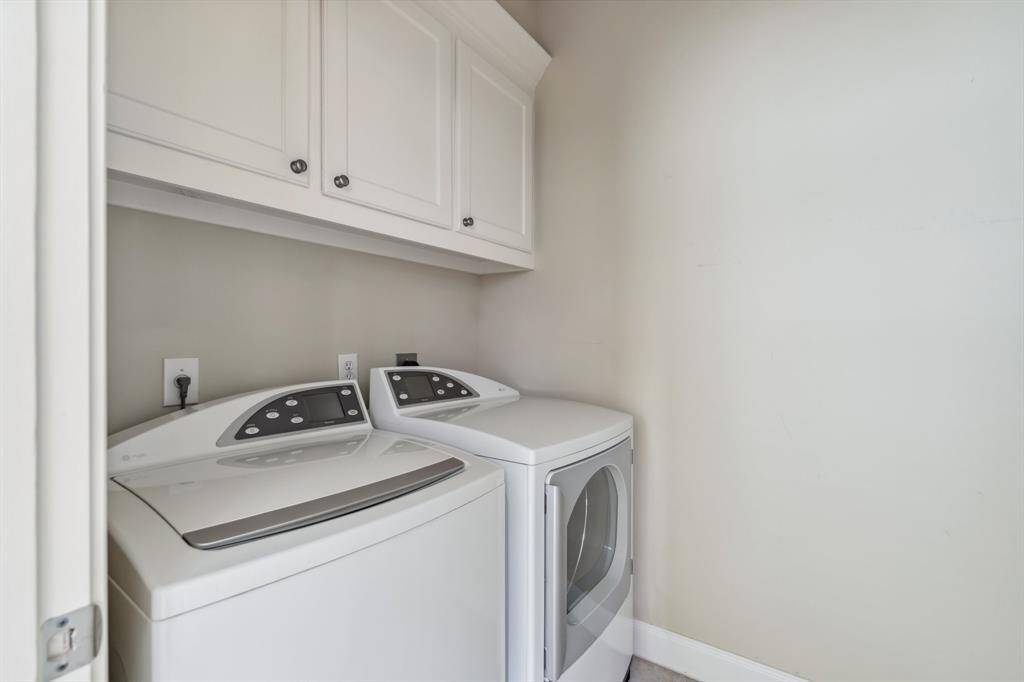Sizable laundry room on the third floor with full-size washer/dryer connections and cabinetry.