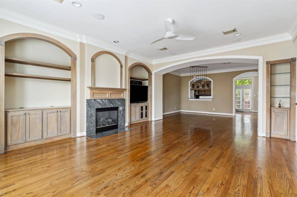 Wide view of the second floor living area showing natural light and connection to the dining space.