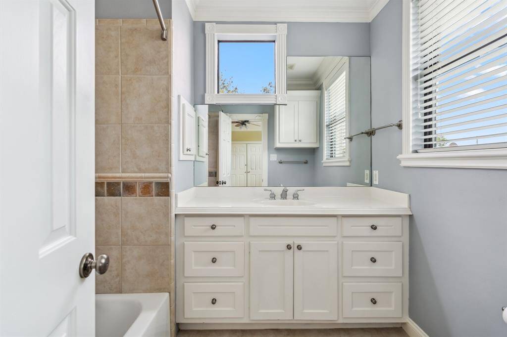 Ensuite bathroom for third floor guest room with tile details.