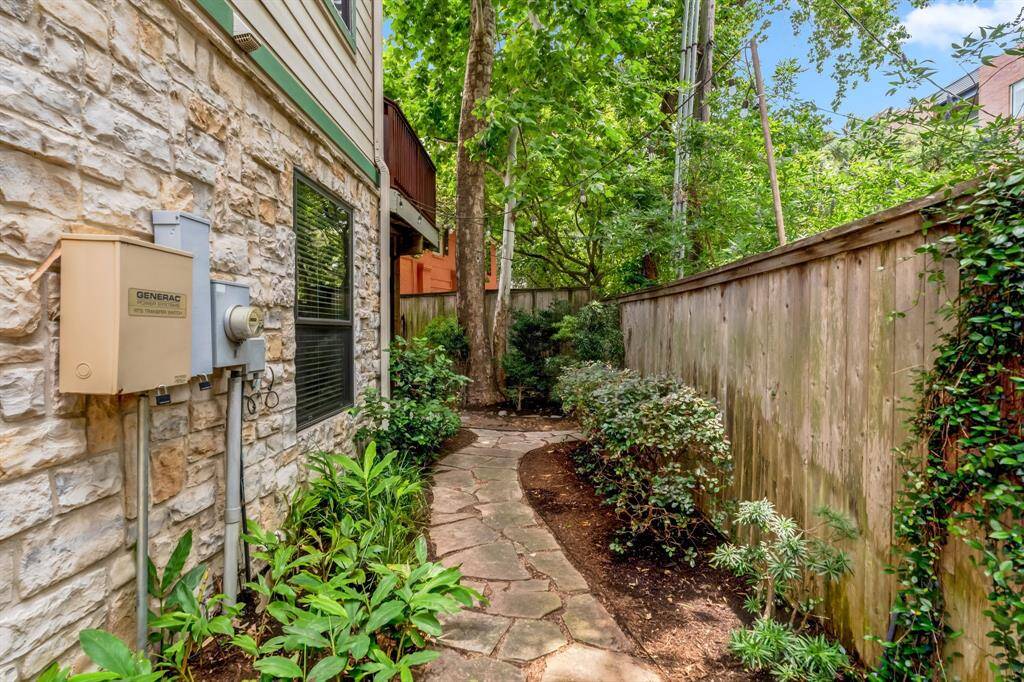 View of side yard showing walkway, privacy fencing, and full access to backyard.