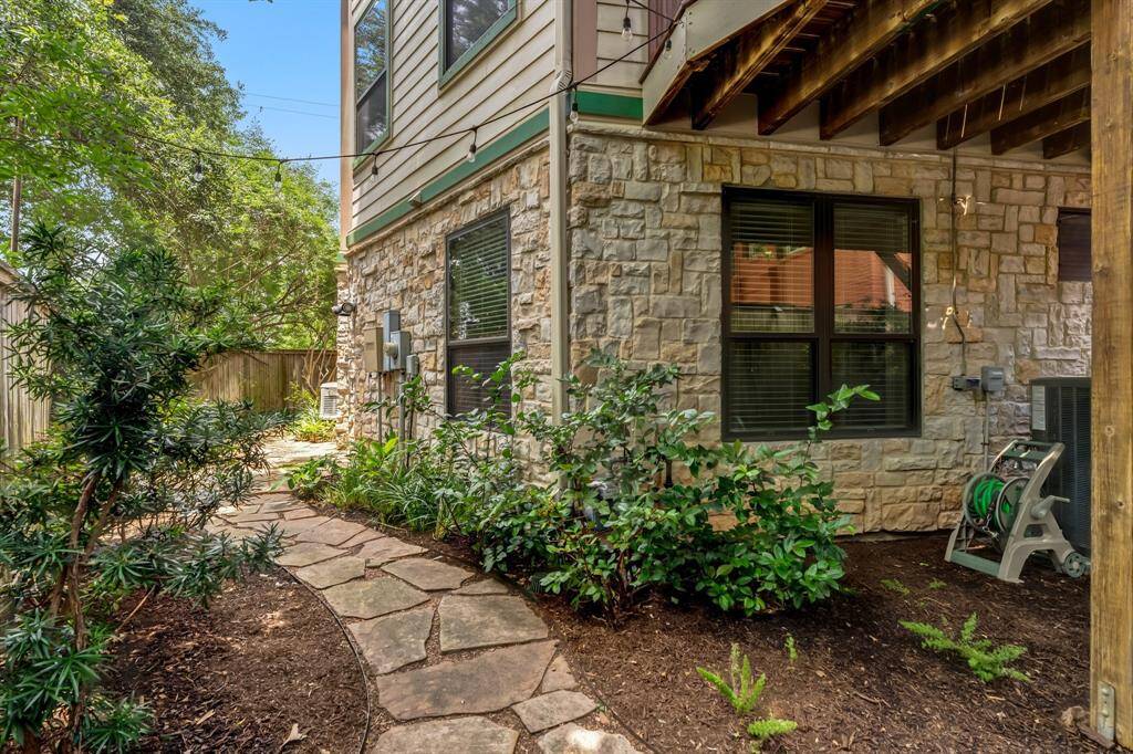 Another view of backyard showing rear elevation and green space.
