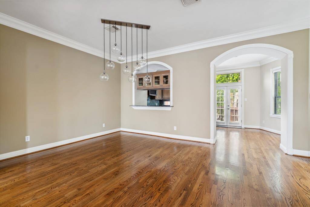 Dining area on second floor with windows on two sides and connection to kitchen and living.