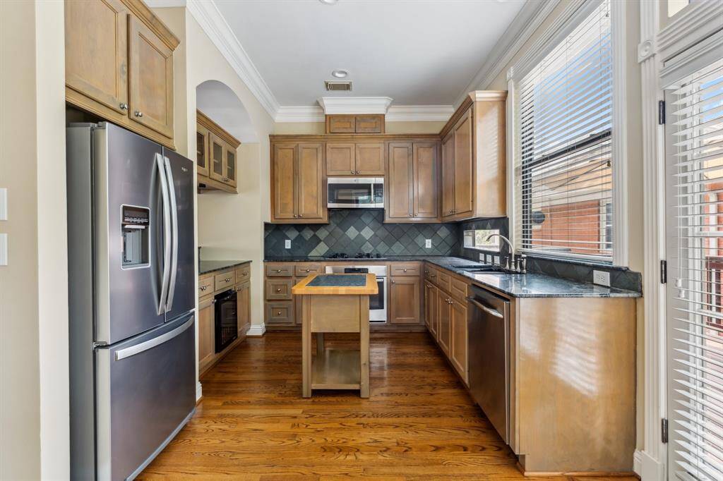 Well-equipped kitchen with generous granite counter space, stainless appliances, and ample cabinetry.