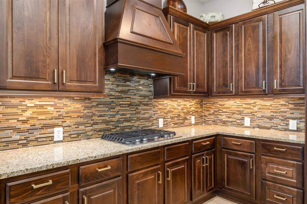 The best view for the chef of the house looking out at your kids or furry friends playing in the backyard with the wall of windows.
