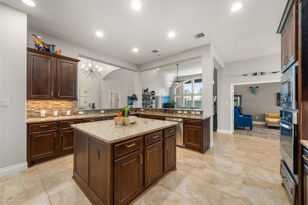 Start your day off right with a cup of coffee sitting with your family in the lovely breakfast area! Featuring neutral paint, tile flooring, recessed lighting and modern chandelier.