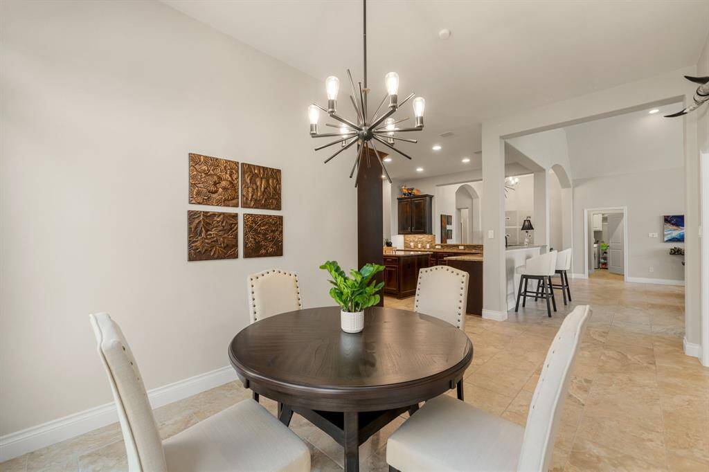 Perfect for entertaining is this amazing game room! Right off the kitchen is this room that would be a fabulous teen hangout, media room, or adult game room complete with pool table and big screen TVs. Featuring vinyl flooring, high trey ceilings, custom paint and large windows with privacy blinds.