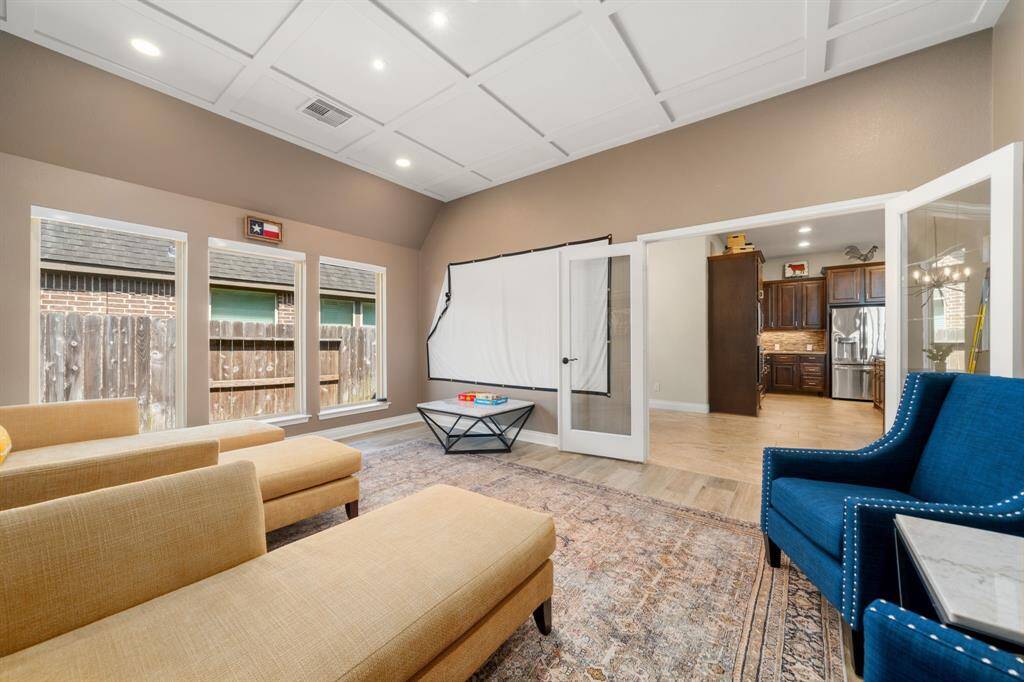 What a wonderful place to come home to! This stunning primary suite greets you with tile floors, custom neutral paint, high ceiling, accent wall, custom ceiling fan with lighting, large windows with blinds allowing in natural light brightening up this spacious primary bedroom with extra space for a seating area.