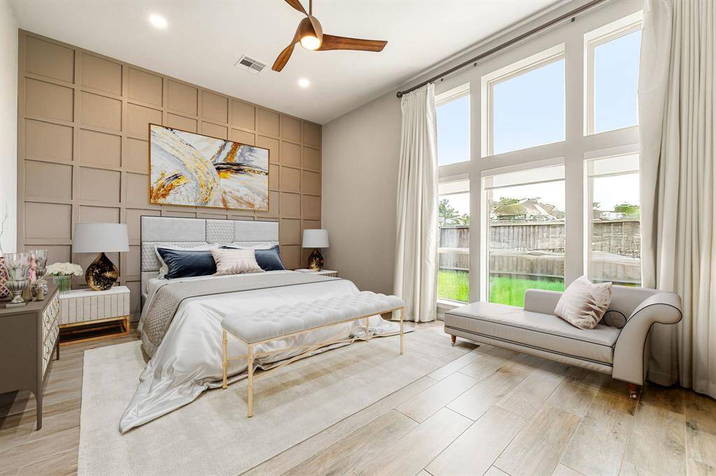 This primary bathroom is definitely move-in ready! Featuring a separate garden tub for soaking after a long day with custom tile detailing, dark stained cabinets with granite countertops, spacious walk-in closet with shelving, high ceilings, neutral paint, sleek and dark modern finishes.