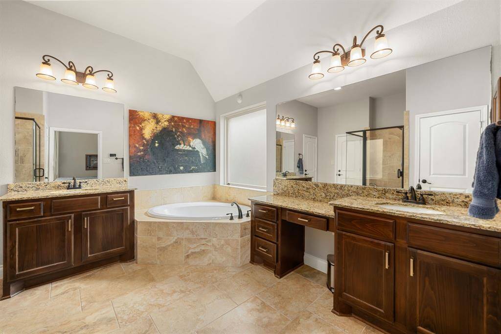 This additional view of the primary bath showcases a walk-in shower with tile surround.