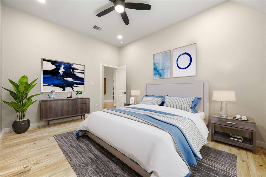 Secondary bathroom features granite countertops and dark cabinets, neutral paint, shower/tub combo with tile surround, large mirror, tile floors, sleek fixtures and plenty of space to accommodate any visiting family or guests.