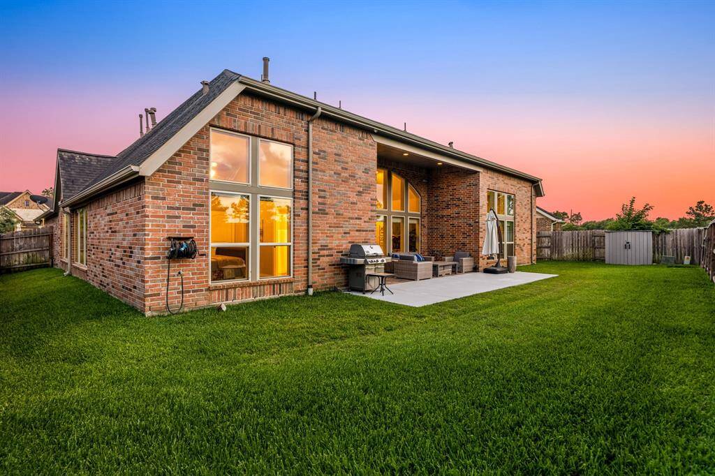 Enjoy your serene backyard at twilight hour under your covered patio with plenty of space for your kids and furry friends to run and play.