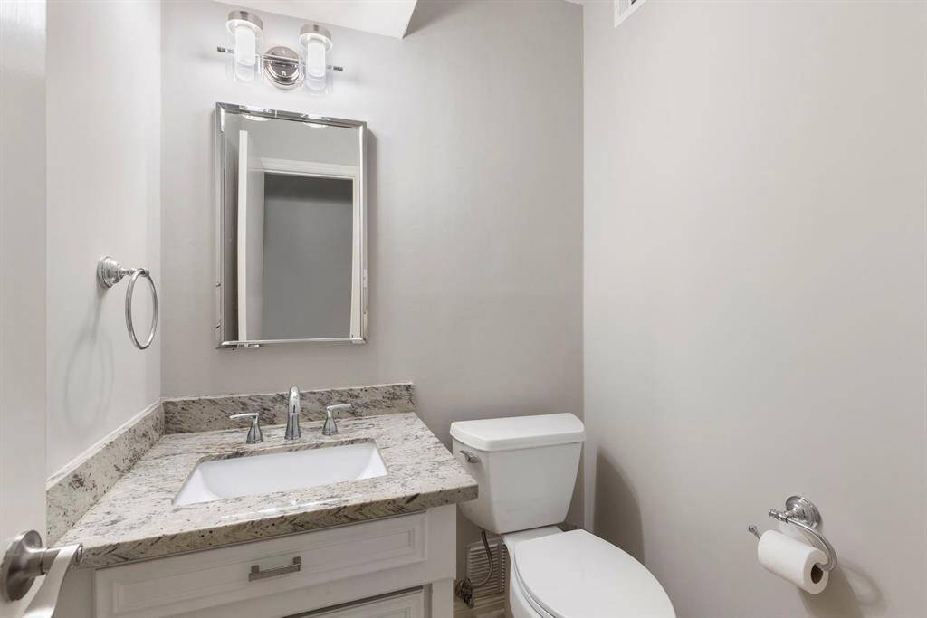 Guest bathroom features an updated vanity and fixtures.