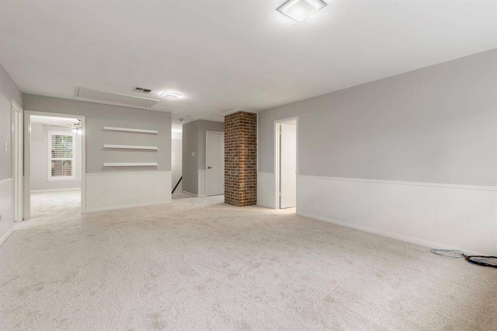 Note the NEW carpet throughout the upstairs and primary bedroom. And don't you love how the character of the brick is displayed here in the spacious game room.