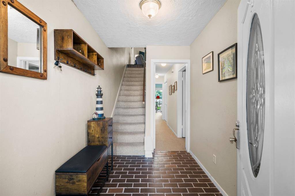 Foyer and hallway to both Bedrooms on Level One and stairs going to level 2
